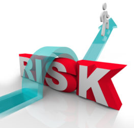 A person jumps over the word Risk to symbolzine avoiding danger or hazards and being careful and prepared to overcome dangerous obstacles